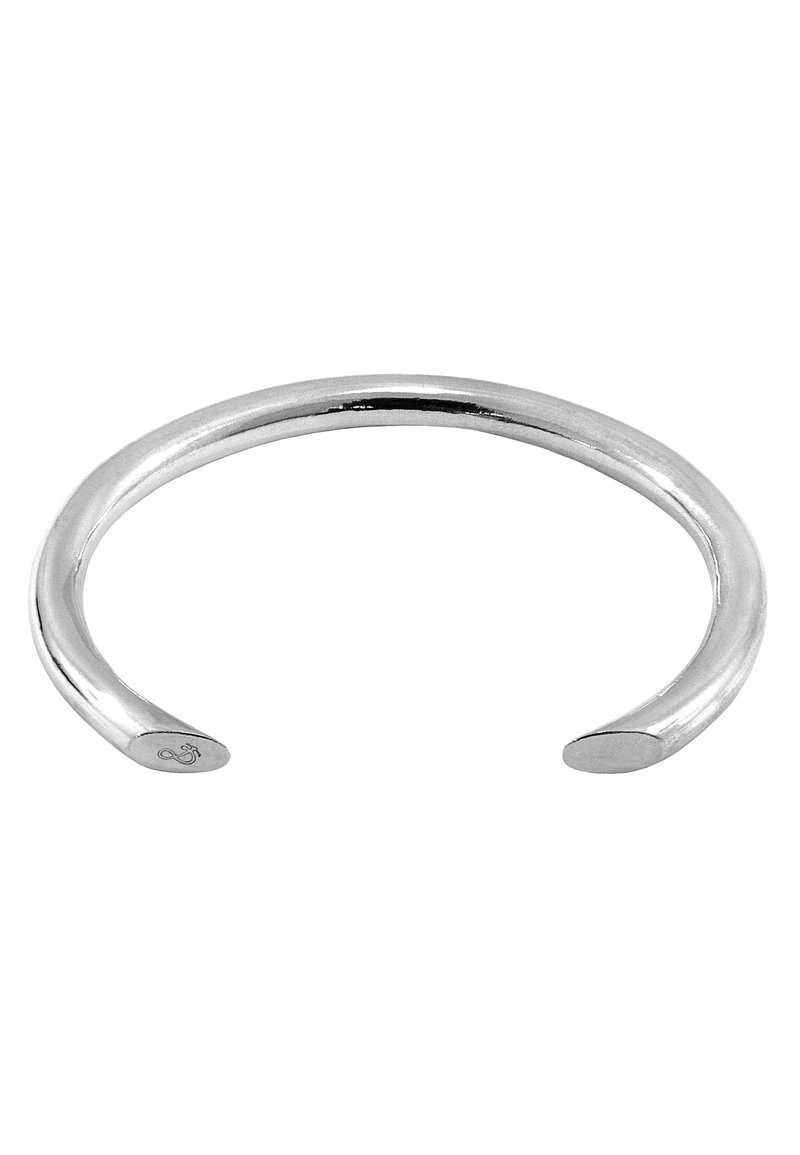 Silver cuff bracelet with a smooth, rounded design. Open-ended, featuring polished metal and subtle engraved detailing on one end.