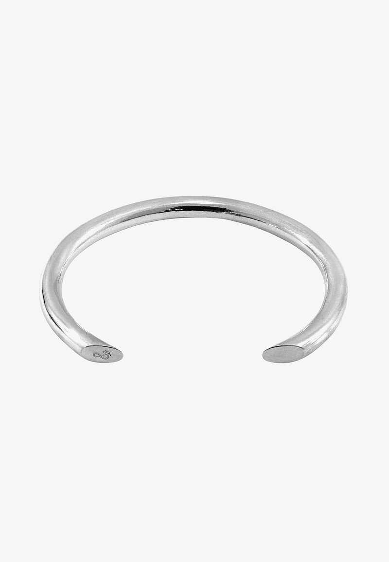 Silver cuff bracelet with a smooth, rounded design. Open-ended, featuring polished metal and subtle engraved detailing on one end.