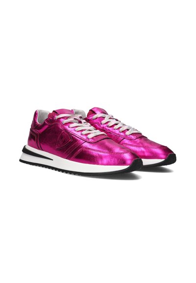 Metallic pink sneakers with white laces, a sleek design, and black rubber soles. Notable feature: shiny, reflective material.