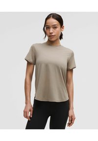 Light beige short-sleeve T-shirt made from soft fabric with a round neckline and relaxed fit. Seamless design for a smooth silhouette.