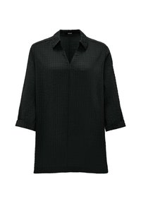 Blouse noire texturée avec un col V, des manches 3/4 et des poignets retroussés. Silhouette simple et droite avec un motif à carreaux subtil.