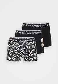 Melnas bokseršorti komplekts ar baltu logotipu vidukļa daļā. Vieniem biksēm ir atkārtots grafiskais raksts; pārējie ir vienkrāsaini melni.