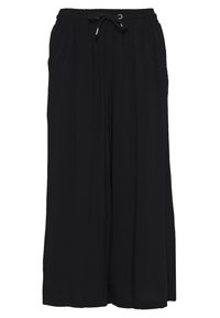 Pantalons noirs à jambe large en tissu léger, avec une taille élastique et un cordon de serrage, arborant une coupe ample et des plis verticaux.