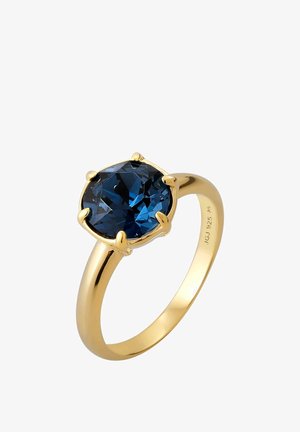 Goldring mit großem, kissenförmig geschliffenem tiefblauem Edelstein, der von sechs Krappen auf einem polierten Band gehalten wird.
