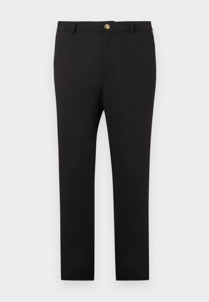 Zwarte slim-fit broek met gouden knoopsluiting en riemlussen, afgebeeld tegen een effen witte achtergrond.