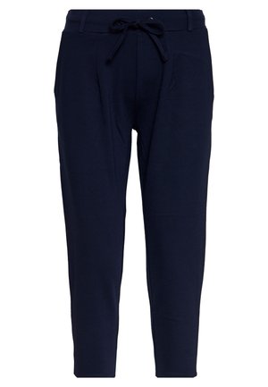 Mørkeblå tapered bukser med elastisk linning, snor, bæltestropper og sidelommer, vist mod hvid baggrund.