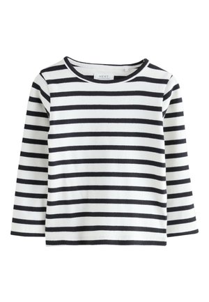 Langærmet, ribstrikket top i hvid med sorte horisontale striber. Har rund halsudskæring og lige kant.
