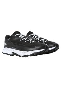Black athletic shoes with a mesh upper, white laces, and a speckled white midsole. Treaded black rubber outsole for traction.