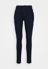 Jeans ajustados de color azul marino hechos de denim, con una cintura alta, cinco bolsillos y un cierre de cremallera con botón. Textura suave.