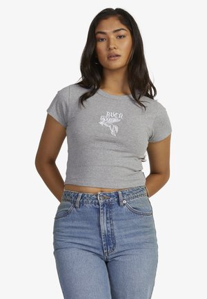 Gray cotton crop top with short sleeves, featuring white graphic text and a flying horse design on the chest. Paired with high-waisted denim jeans.