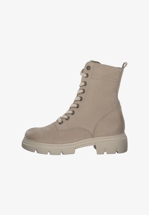 Beige leather ankle boot with a round toe, textured upper, prominent laces, and a chunky rubber sole. Features a pull tab and eyelets.