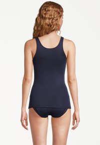 Navy tank top in a fitted design, made of soft fabric, with a round neckline and thin straps, paired with matching bikini bottoms.