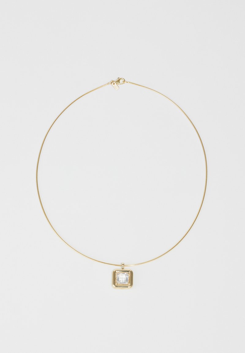 Gold necklace with a thin chain, featuring a square transparent pendant encased in a gold setting. Smooth texture and minimal design.