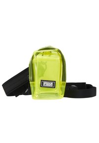Gjennomsiktig neon grønn pose med glidelås, svarte stropper og et "Urban Classics" logo merke på forsiden. Kompakt og rektangulær design.