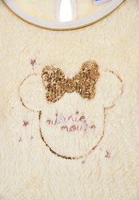 Cremefarbene, flauschige Fleecejacke mit einer goldenen Pailletten-Schleife und einem pink gestickten Design eines MäusesGesichts, umgeben von Sternen.