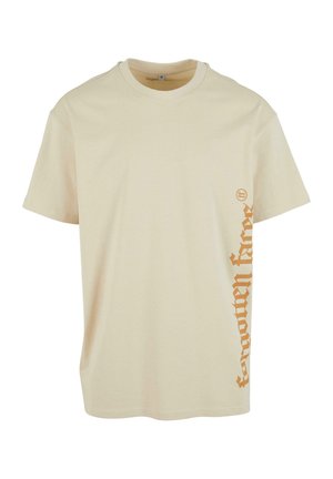 Cream-colored cotton t-shirt featuring short sleeves, a round neck, and orange vertical text design on the left side.