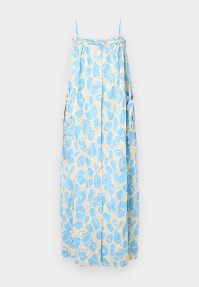 Dlhé šaty v svetlo béžovej farbe s modrými abstraktnými vzormi, s tenkými ramienkami, bočnými vreckami a voľným strihom. Jemná textúra látky.