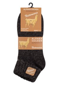 Calzini in alpaca grigio scuro con bordo a coste, etichettati con la taglia 39/42. Il packaging presenta un'illustrazione di un alpaca su uno sfondo marrone.