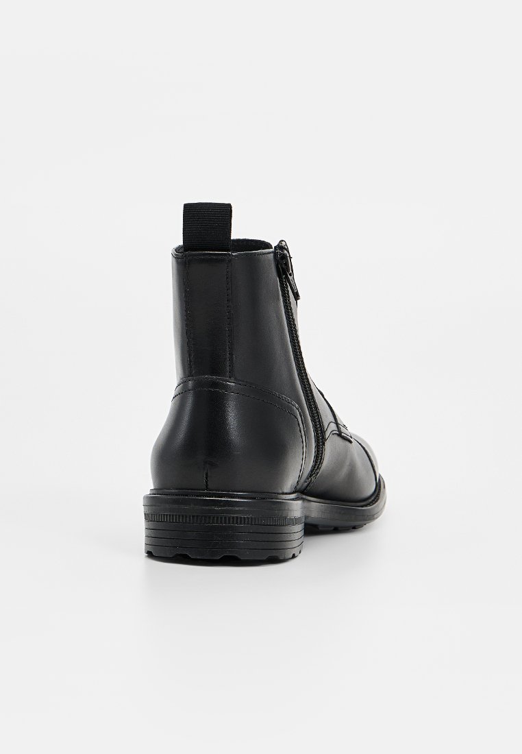 Czarne skórzane botki za kostkę z tylnym zamkiem, okrągłym noskiem, teksturowaną gumową podeszwą oraz pętlą do zakupu z tyłu. Gładkie wykończenie.