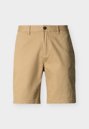 Béžové šortky do kolen s knoflíkovým zapínáním, poutky na pásek a hladkým předním dílem, zobrazené na jednobarevném pozadí.