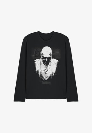 Black long-sleeve shirt with a white graphic of a bald man in a suit and tie, with "Daredevil" text below on a brick wall background.