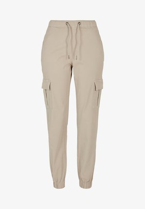 Bežid cargo püksid elastse vöökoha ja paelaga, millel on kaks külgetaskut ja kitsenevad pahkluud. Valmistatud pehmest ja kergekoelisest kangast.