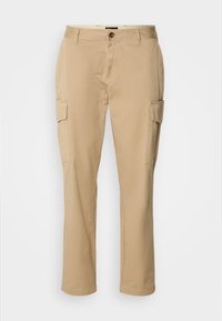 Beige cargo pants made of cotton. Features two side pockets, a button closure, and a straight-leg design. Smooth texture, casual style.