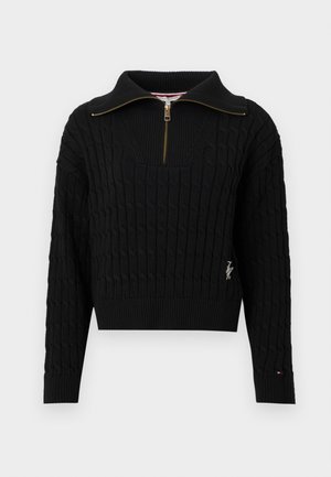 Zwarte gebreide trui met een hoge kraag, ritssluiting aan de voorkant, geribbelde manchetten en boord. Heeft een gestructureerd patroon en een logodetail aan de zijkant.