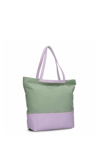Groene canvas draagtas met een lila leren bodem, voorzien van dubbele schouderbanden en een ronde accentdetail aan de voorkant.