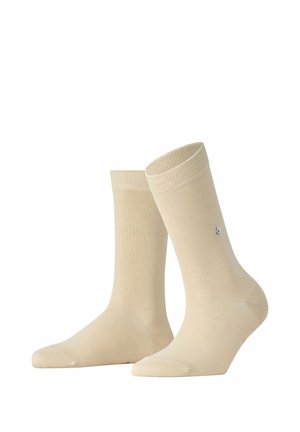 Par de calcetines beige de longitud hasta la pierna con puño acanalado, mostrados en posición vertical sobre fondo blanco.