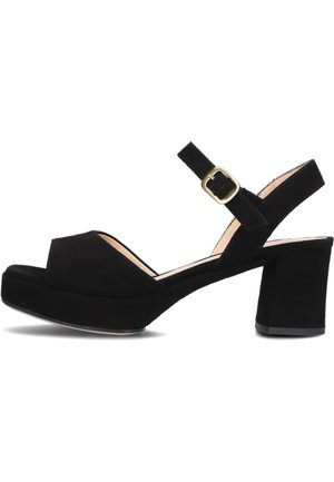 Black suede platform sandals with an open toe, ankle strap, and gold buckle, featuring a chunky heel and smooth texture.