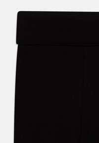 Lindex TROUSERS FLARES YOGA - Hlače - black