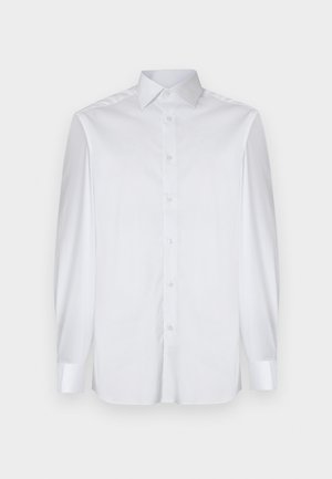 Bela srajca z dolgimi rokavi iz gladkega blaga, z nazobčanim ovratnikom, gumbnim zapiranjem spredaj in kontrastnimi manšetami. Brez vidnih vzorcev.