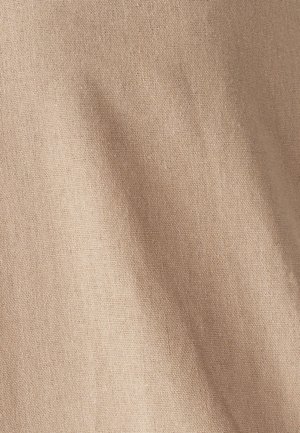 Beige, textured fabric shows a soft, woven surface with slight creases, ideal for apparel or home textiles.