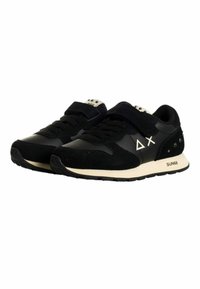 Scarpe sportive nere in materiali scamosciati e in pelle, con un cinturino in velcro, dettagli bianchi e una suola nera strutturata.