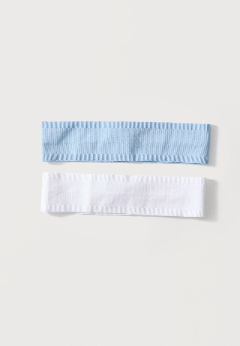 Deux bandeaux en tissu côtelé, un bleu clair et un blanc, posés à plat sur un fond blanc uni.