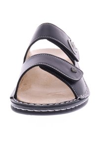 Black leather sandals with two wide upper straps, open toe design, beige textured insole, and white stitching along the edges.