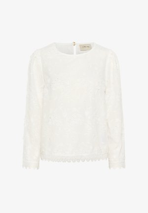 Balts garām piedurknēm krekliņš ar ziedu izšuvumu. Iezīmes: apaļa kakla izgriezums, viļņota apakšmala un atvērums aizmugurē ar zelta akcentu.