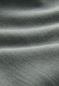 Textured fabric in shades of muted blue and gray, featuring a wavy pattern and soft, smooth surface, ideal for various applications.