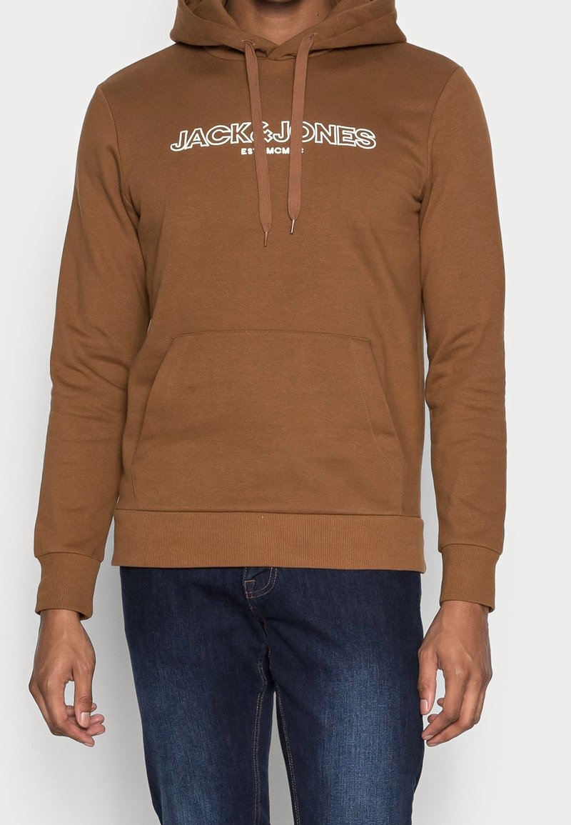 Brown hoodie with a kangaroo pocket, drawstring hood, and white "JACK & JONES" logo. Fabric appears soft with a smooth texture.