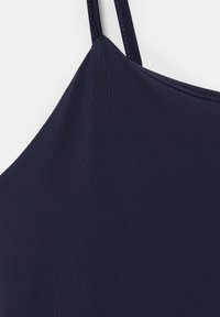 Haut sans manches bleu marine avec fines bretelles réglables, tissu lisse et encolure droite sur fond blanc.