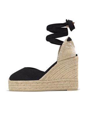 Espadrille compensée en toile noire avec plateforme en jute tissé et liens à nouer autour de la cheville.