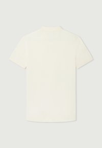 Kortärmad polo t-shirt i krämfärgad, med en klassisk krage. Tyget har en mjuk yta utan synliga mönster eller accenter.