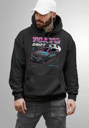 Black hoodie featuring a graphic design of a drifting car and text "Tokyo Drift" in pink and turquoise. Includes a kangaroo pocket and drawstring hood.