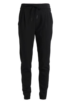 Black, tapered sweatpants with an elastic waistband and adjustable drawstring, featuring side pockets and a soft, textured fabric.