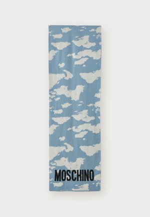 Light blue scarf featuring a cloud pattern in white, with "MOSCHINO" in bold black lettering along the bottom edge. Soft texture and rectangular shape.