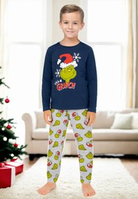 Maglietta da pigiama a maniche lunghe blu navy con grafica del Grinch; pantaloni del pigiama grigi con illustrazioni colorate del Grinch e dettagli natalizi.