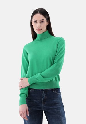 Green turtleneck sweater in lightweight knit fabric. Features ribbed cuffs and hem, with a fitted silhouette. Paired with dark jeans.
