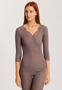 Brown ribbed long-sleeve top with a lace-trimmed V-neck and lace accents at three-quarter sleeves, made from a soft, stretchy fabric.