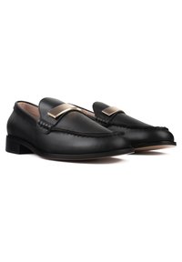 Black leather loafers featuring a sleek design, rounded toe, and a gold accent on the vamp. Textured stitching adds detail to the upper.